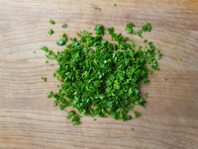 chopped parsley on a wooden chopping board