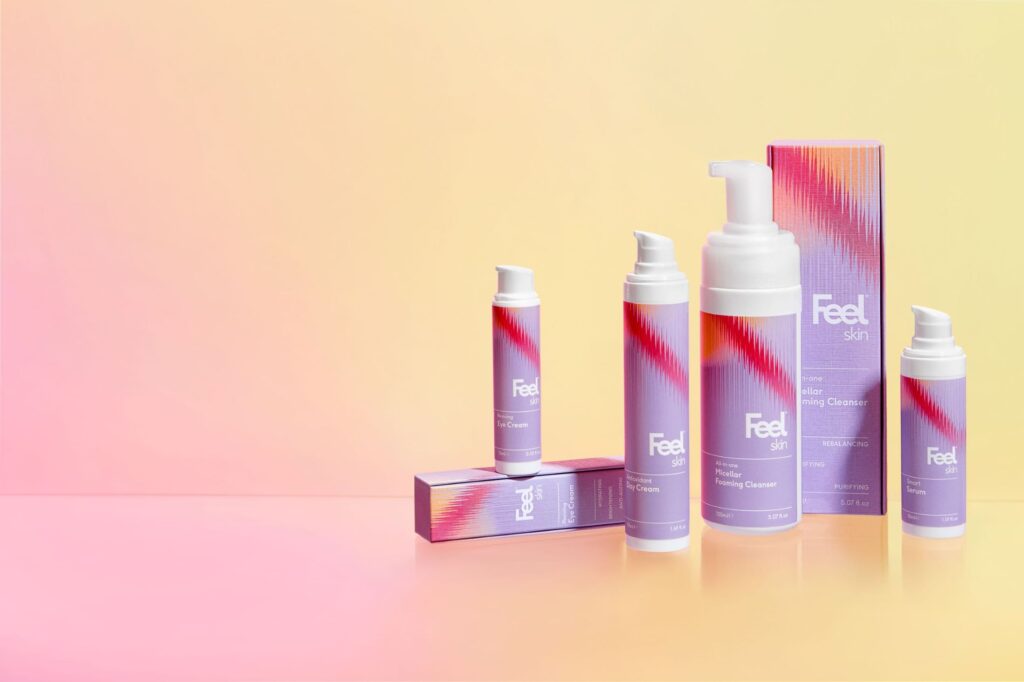 Range of Feel Skincare products against a pink and yellow background