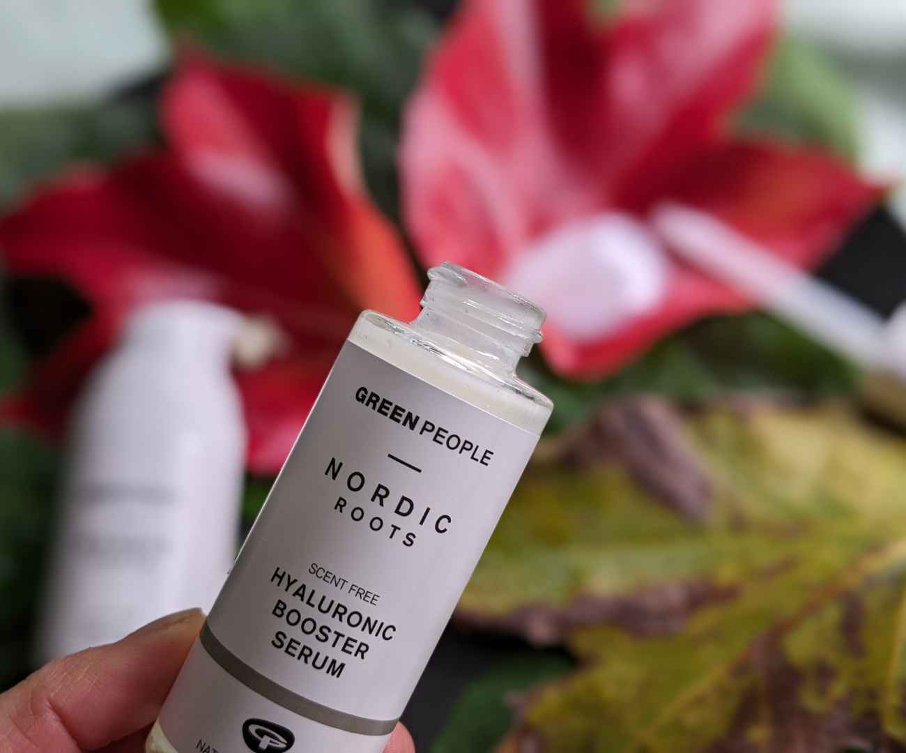 Small white labelled bottle containing Green People Nordic Roots serum, containing hyaluronic acid to illustrate this vegan winter skincare guide